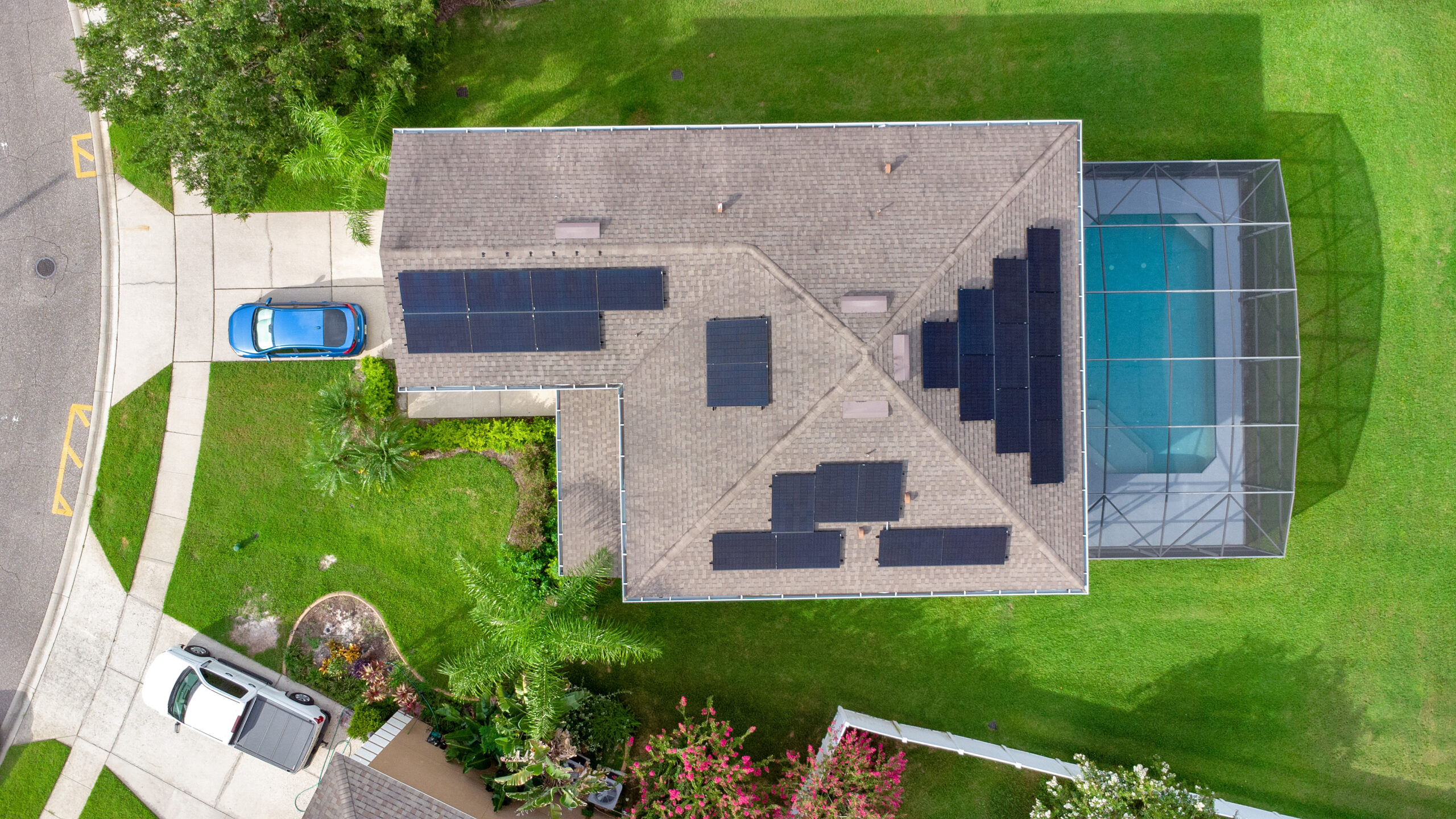 overhead view of black solar panels on the light-brown roof of an Oviedo home