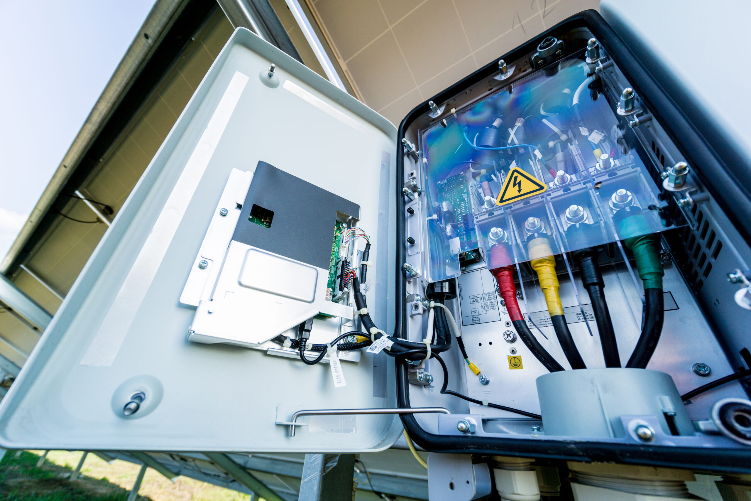 Opened solar inverter showing the wiring and electrical components