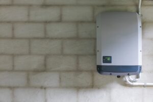 string solar inverters mounted on the inside of a garage wall