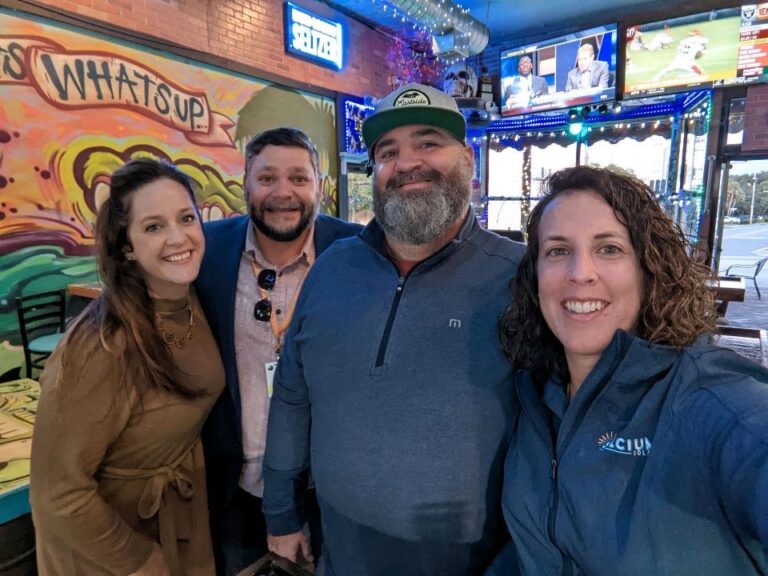 Members of Solcium Solar celebrating a commercial solar partnership with the owner of Celery City Craft in Historic Downtown Sanford