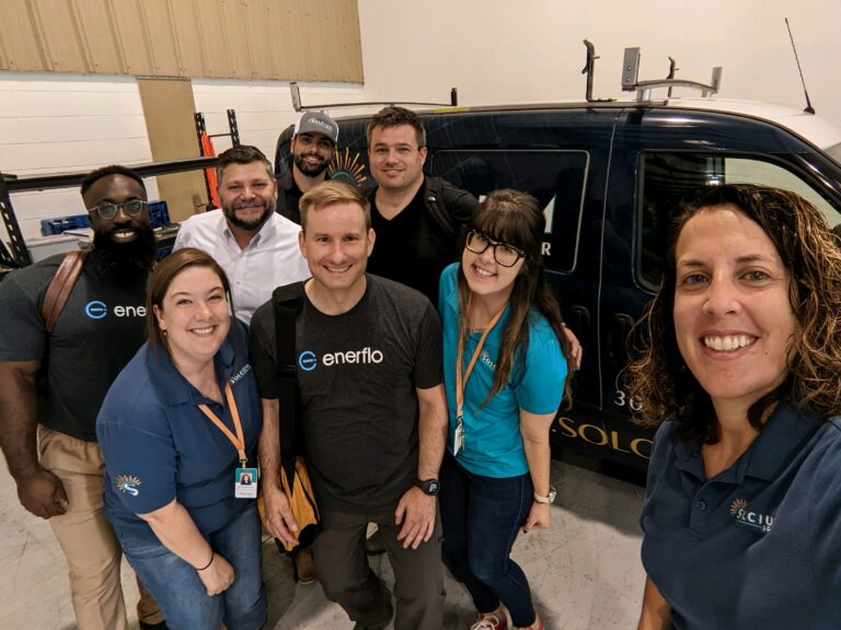 Solcium Solar employees in the Sanford warehouse posing with reps from Enerflo