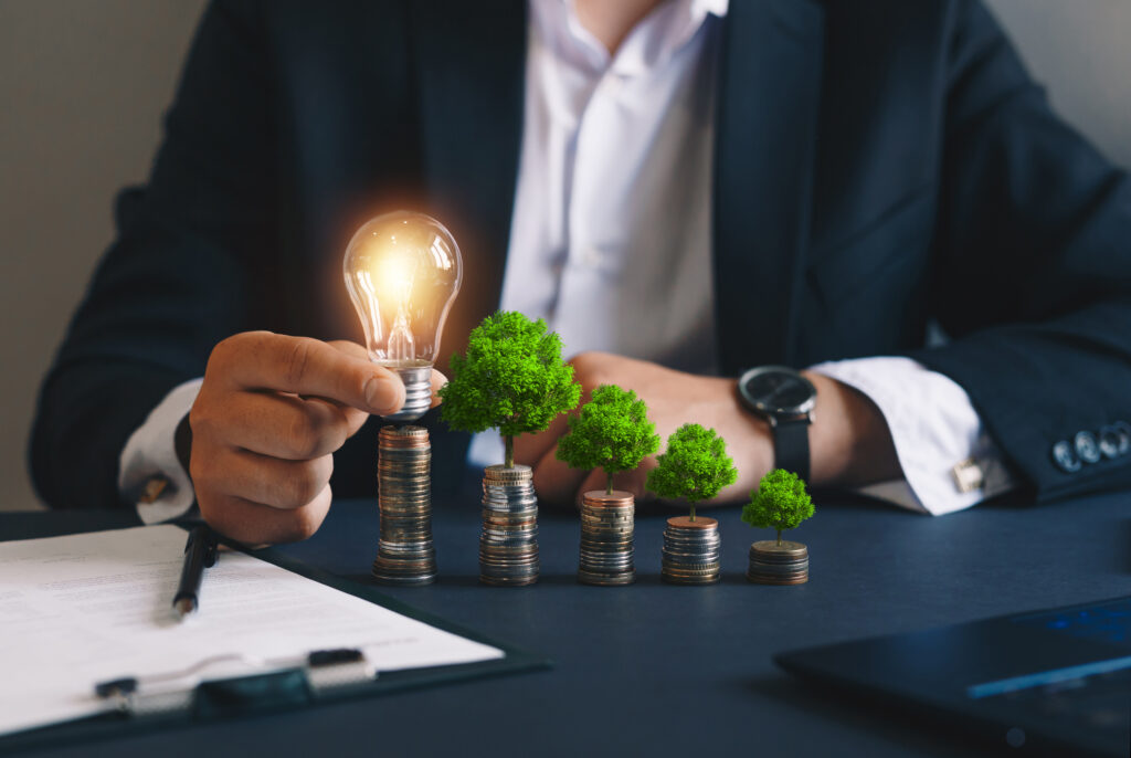 Commercial business man holding a light bulb and assessing profits after investing in solar energy