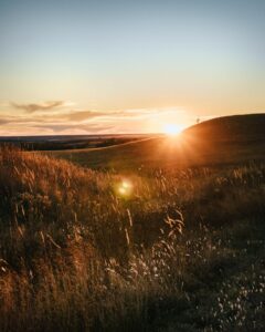 Sunset over a field of hills in Kansas