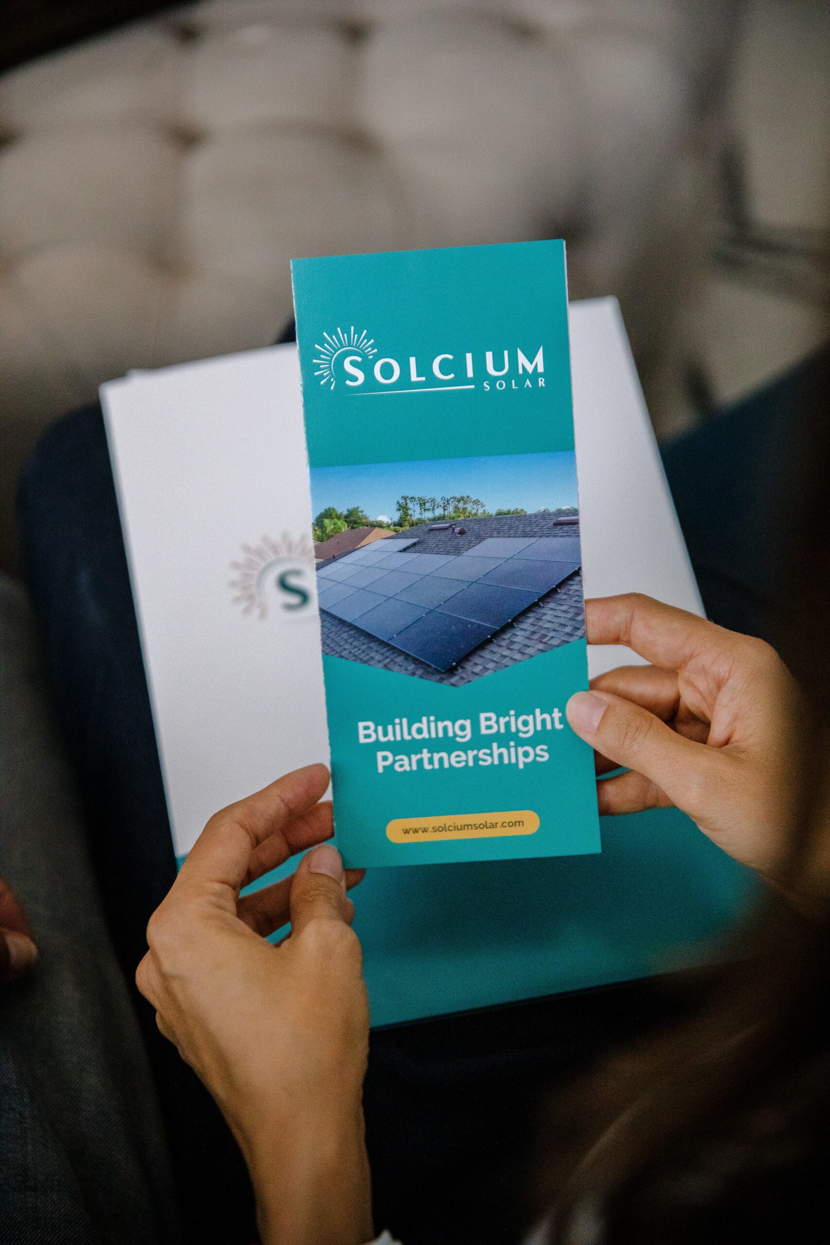 Solcium Solar customer holding a brochure in their hands that describes The Solcium Difference and Solcium's services.