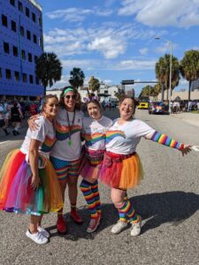 Women of Solcium Solar posing at the Pride Parade in Orlando, Florida