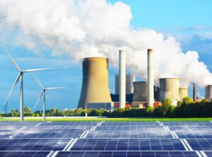 Image of a coal and fossil fuel plant in the distance with solar panels and windmills in front of them to represent conventional energy sources versus renewable energy sources.