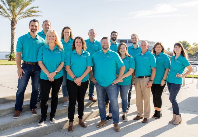 Solcium Solar Leadership team posing together in Sanford, Florida by the Sanford Riverwalk