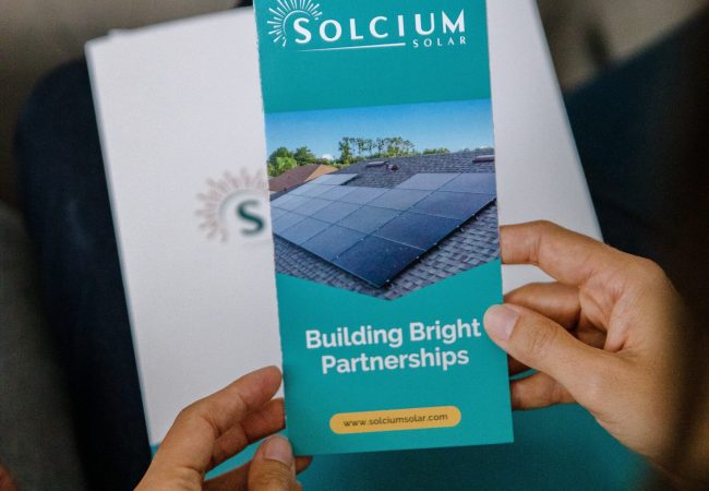 Solcium Solar customer holding a brochure in their hands that describes The Solcium Difference and Solcium's services.